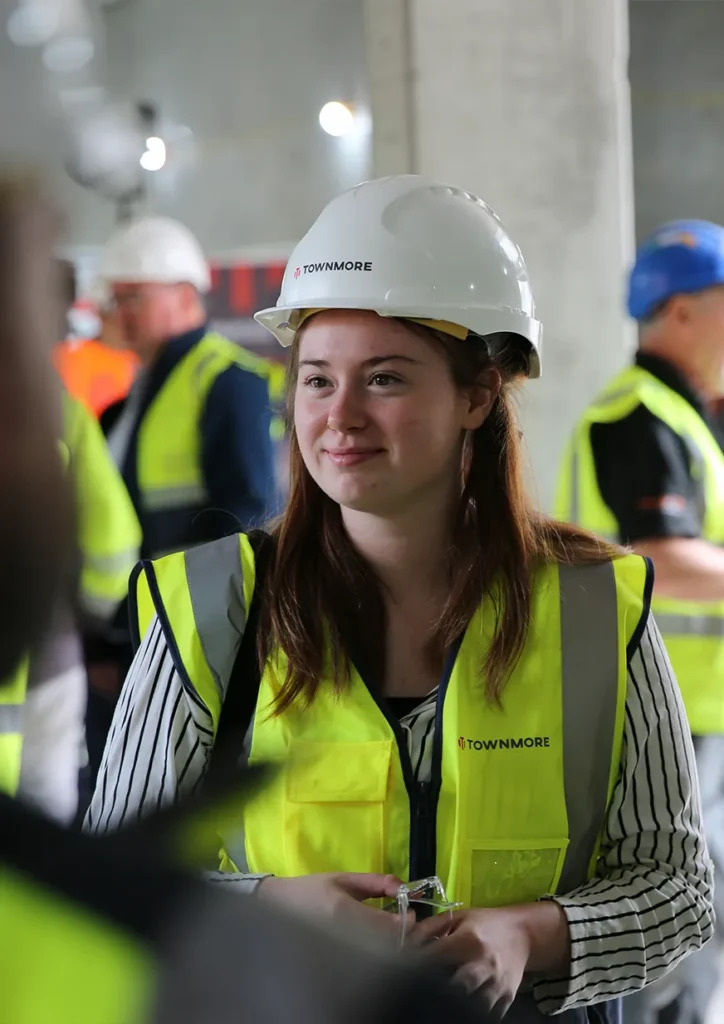 Young woman in hard hat and high vis vest