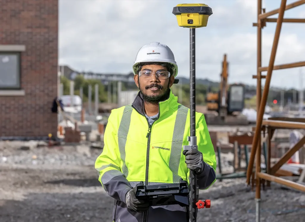 Construction worker with equipment on building site