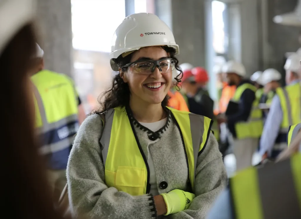 Young woman as part of a group in high vis on construction site